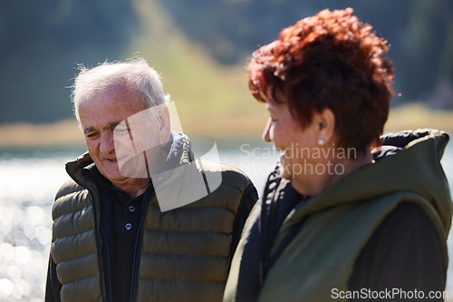 Image of Elderly couple strolling through the breathtaking beauty of nature, maintaining their vitality and serenity, embracing the joys of a health-conscious and harmonious lifestyle