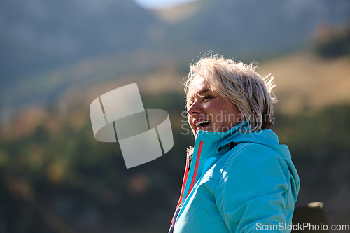 Image of A senior woman finds serenity and wellness as she strolls through nature, illustrating the beauty of maintaining an active and health-conscious lifestyle in her golden years