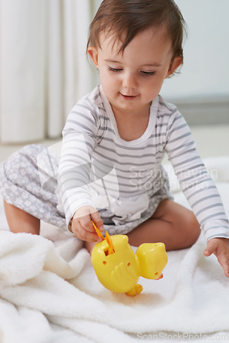 Image of Baby, playing and toys in living room floor, duck and sensory growth in family home. Curious, girl and play for child development, games and childhood memories or fun to learn, cognition or kids