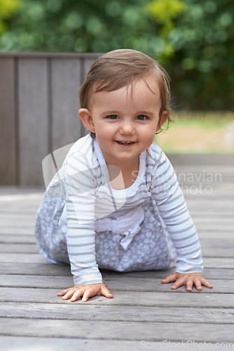 Image of Baby girl, crawling outside and portrait on floor, child development and growth with sensory coordination. Girl, cognition and healthy in good mood, childhood or balance with arms, kid or adorable