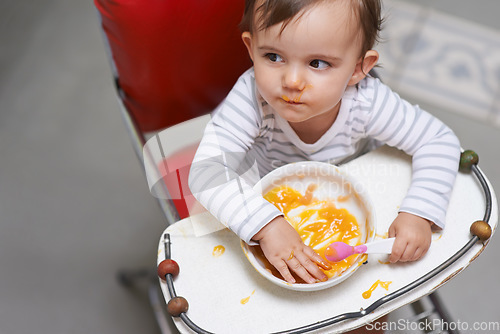 Image of Baby, girl in high chair with food, nutrition and health for childhood development and wellness. Healthy, growth and toddler at home, feeding vegetable or fruit with hungry kid eating a meal