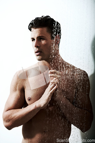 Image of Man in shower with muscle, clean body and splash for morning wellness, hygiene and skin routine in home. Grooming, skincare and relax, male model washing in water with self care and calm bathroom.