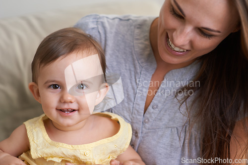 Image of Mother, baby and portrait smile in relax of adorable and happy little girl sitting on mommy at home. Face of mama holding young newborn child, kid or toddler for parenting, bonding or love at house