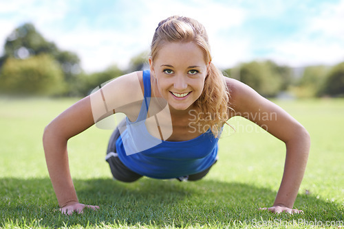 Image of Women, face and push ups on grass for exercise with fitness, training and workout on sports field. Athlete, person and confidence on ground with physical activity for healthy body or wellness outdoor