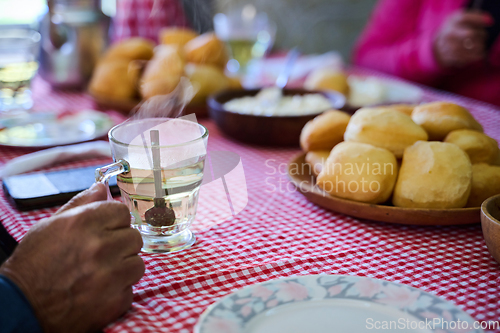 Image of An enticing top down view captures a delightful breakfast tableau, featuring freshly baked bread, delectable jam, and a comforting cup of tea a simple yet satisfying morning feast