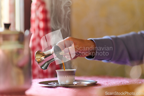 Image of Elderly woman savors the serenity of the morning as she enjoys a cup of coffee on the porch of her rustic cottage, finding solace in the simplicity of nature and contemplative moments