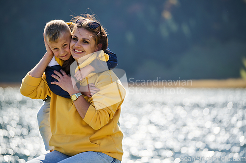 Image of A mother and son create cherished memories as they playfully engage in outdoor activities, their laughter echoing the joy of shared moments and the bond between parent and child