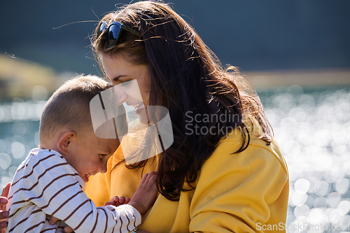 Image of A mother and son create cherished memories as they playfully engage in outdoor activities, their laughter echoing the joy of shared moments and the bond between parent and child