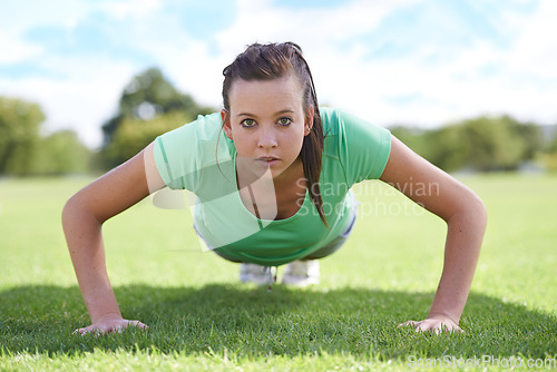 Image of Women, portrait and push ups on grass for training with exercise, fitness and workout on sports field. Athlete, person and confidence on ground with physical activity for healthy body and wellness