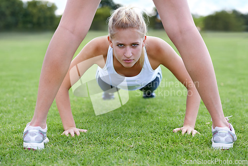 Image of Women, portrait and push ups on field for fitness with exercise, training and workout on grass for sport. Athlete, person and confidence on ground with physical activity for healthy body and wellness
