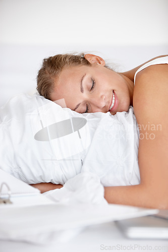 Image of Happy, woman and relax in bed or sleeping in home with happiness from casual or remote work. Morning, bedroom and calm person hugging duvet with a smile for comfort in apartment with project