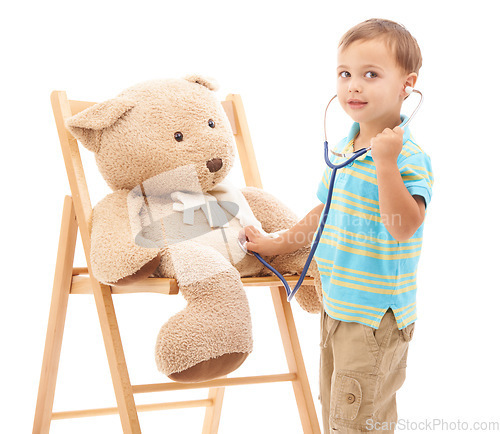 Image of Boy kid, teddy bear and stethoscope in studio for playing doctor, listening and wellness by white background. Child, healthcare game and development with plush toys, medical check or consultation