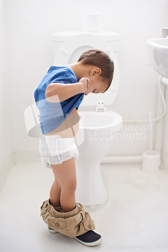 Image of Boy child, potty training and toilet with thinking, diaper and pants on floor for learning, development and progress. Kid, family home and bathroom with ideas, problem solving or solution in nappy