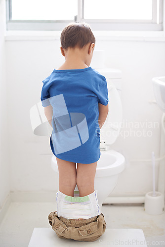 Image of Boy kid, potty training and toilet with thinking, diaper and pants on floor for learning, development and progress. Child, family home and back in bathroom with ideas, hygiene or solution with nappy
