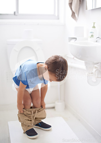 Image of Child, bathroom and toilet training in diaper or learning growth, milestone or hygiene. Male person, kid and pants or step for development in home for parent care for toddler teaching, health or love