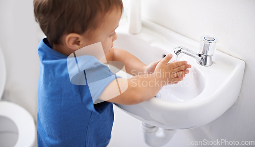 Image of Child, boy and water for washing hands in bathroom, hygiene and prevention of germs or bacteria at home. Male person, kid and learning at basin or cleaning and sanitary, liquid soap and disinfection