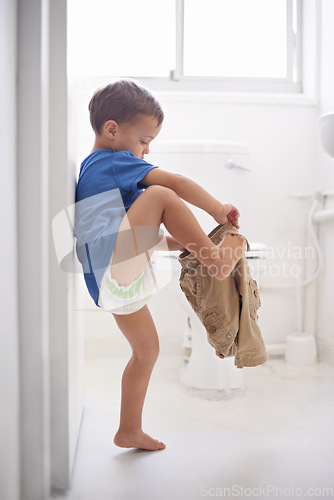 Image of Child, bathroom and toilet training for learning growth, milestone or hygiene. Male person, kid diaper and pants or step for development in home for parent care for toddler teaching, health or love