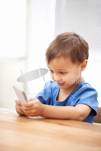 Image of Child, boy and relaxing on smartphone or texting, connection and playing games on technology. Male person, home and mobile application for social media, browsing website and scrolling on internet