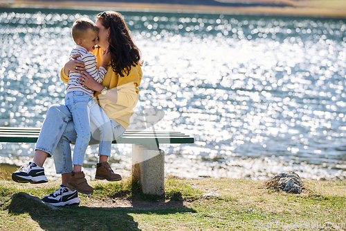 Image of A mother and son create cherished memories as they playfully engage in outdoor activities, their laughter echoing the joy of shared moments and the bond between parent and child