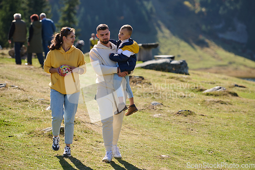 Image of A modern family, along with their son, revels in the joy of a muddy day in nature, running and playing together, encapsulating the beauty of a healthy and active lifestyle