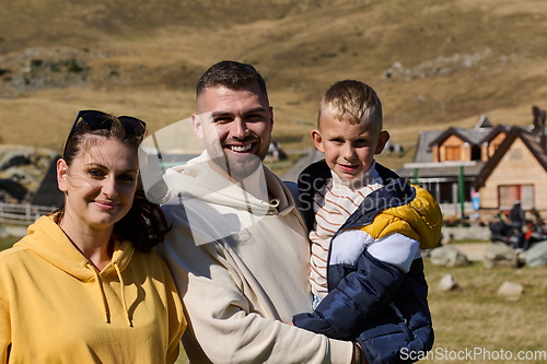 Image of A modern family, along with their son, revels in the joy of a muddy day in nature, running and playing together, encapsulating the beauty of a healthy and active lifestyle