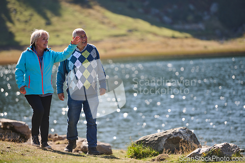 Image of Elderly couple strolling through the breathtaking beauty of nature, maintaining their vitality and serenity, embracing the joys of a health-conscious and harmonious lifestyle