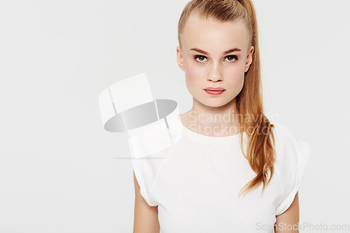 Image of Serious, teenager and portrait with fashion in studio and white background with confidence and pride. Beauty, face and girl with a ponytail in casual trendy style with makeup in mock up space