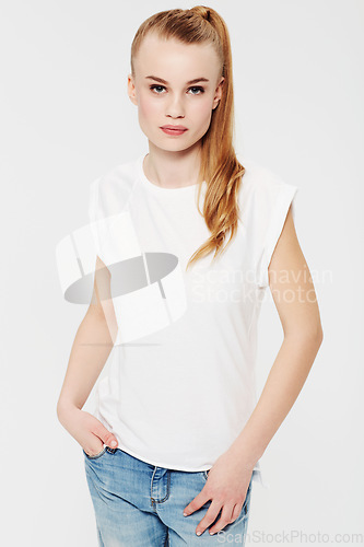 Image of Serious, portrait and teenager with fashion in studio and white background with confidence and pride. Beauty, face and girl with a ponytail in casual trendy style, jeans and relax in mock up space