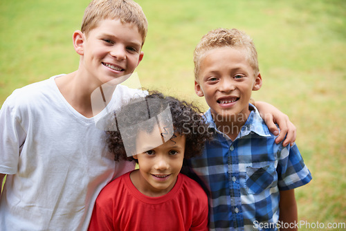 Image of Boys, friends and portrait or happy on field in summer with confidence, pride or diversity in nature. Children, face or smile on grass with embrace for friendship, care and support on playground