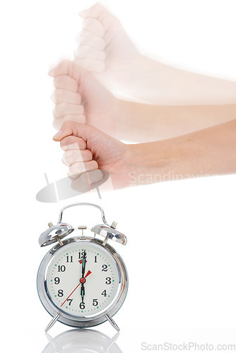 Image of Person, hand and hitting alarm clock for alert, wakeup or deadline on a white studio background. Closeup of fist slamming down on time for stop in motion blur, schedule or management for planning