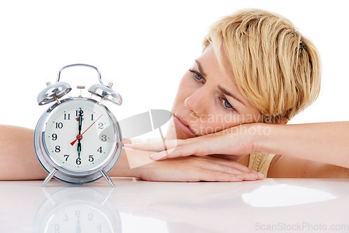 Image of Sad woman, alarm clock and alert for wakeup or deadline on a white studio background. Upset or disappointed female person or blonde looking at time in failure, loss or bored on table on mockup space