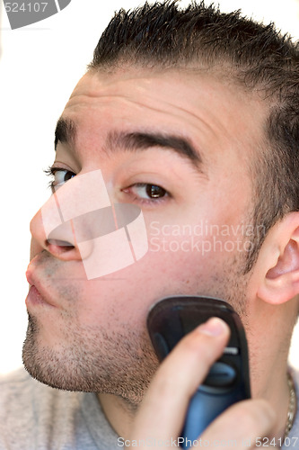 Image of Young Man Shaving