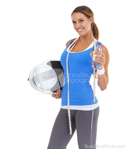 Image of Woman, water bottle and scale in studio for health, diet and exercise, fitness or wellness results on a white background. Portrait of sports model with measure tape and liquid for training progress