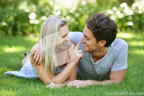 Image of Couple, relax in park and smile with love and commitment in healthy relationship. People on grass on date outdoor, nose touch and care with trust, partner and bond together for marriage and romance