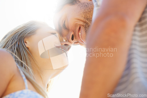 Image of Forehead, eye contact or happy couple hug in outdoor on date for support or love in nature together. Low angle, romantic man or woman with smile on holiday vacation for fun bond, travel or wellness