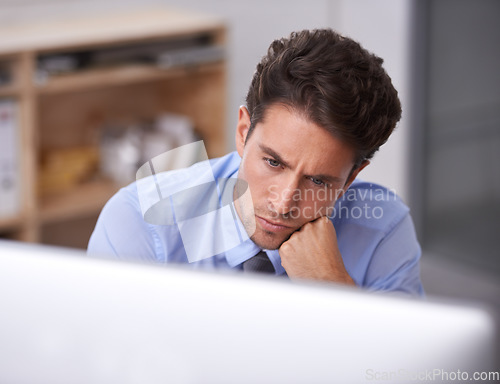 Image of Business man in office, thinking and productivity, lawyer busy with case research, review and analysis. Professional, workflow and reading on computer with attorney in workplace, expert and solution