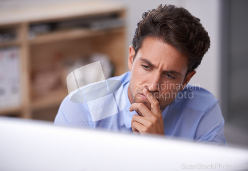 Image of Business man in office, thinking and reading on computer, lawyer busy with case research, review and analysis. Professional, workflow and productivity with attorney in workplace, expert and solution