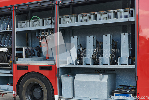 Image of Close-up of essential firefighting equipment on a modern firetruck, showcasing tools and gear ready for emergency response to hazardous fire situations