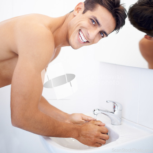 Image of Man, washing hands and portrait for hygiene in mirror, clean and protection from germs. Male person, bathroom and wellness in morning routine, reflection and grooming or self care and basin at home