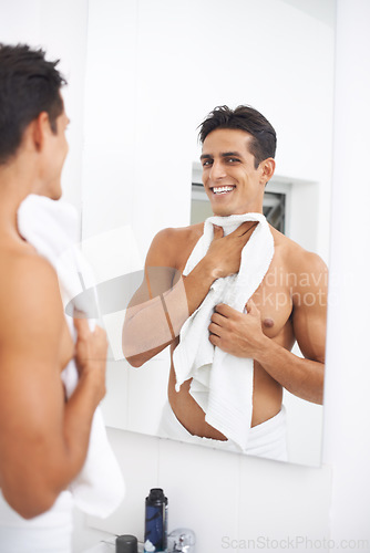 Image of Man, shower and towel after washing in mirror, cleaning and skincare or smile for beauty. Male person, bathroom and wellness in morning routine, reflection and grooming or self care and joy at home