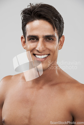 Image of Man, portrait and smile for skincare in studio, cosmetology and glow by gray background or shine. Male person, face and happy for beauty and dermatology, care and satisfaction in facial treatment