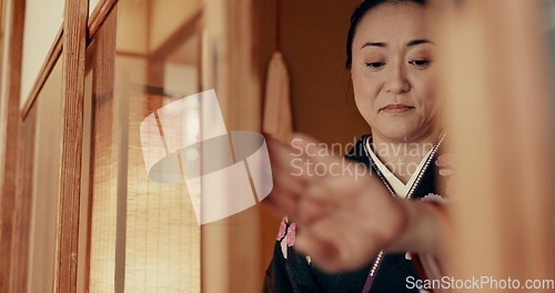 Image of Japanese, woman and kimono in corridor or tradition in chashitsu room with indigenous fashion or clothing. Person, ritual and ceremony for temae, wellness and zen in architecture building in Tokyo