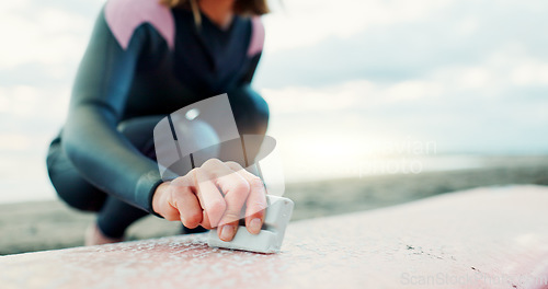 Image of Surfing, ocean and woman with wax for surfboard for water sports, fitness and freedom on beach. Nature, travel and happy Japanese person on sand for wellness on holiday, vacation and adventure by sea