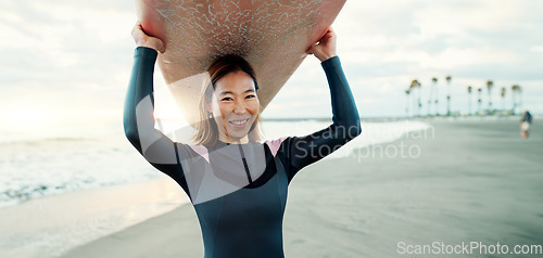 Image of Surfing, beach and portrait of woman with surfboard for water sports, fitness and freedom by tropical ocean. Nature, travel and happy Japanese person on sand on holiday, vacation and adventure by sea