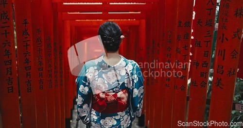 Image of Woman, shinto religion or back by gates in japan, spiritual path or indigenous culture in kimono. Person, traditional clothes or worship in peace, respect or heritage by Fushimi Inari Taisha in kyoto