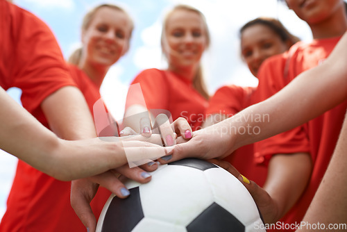 Image of Happy woman, soccer ball and hands together for teamwork, unity or motivation on outdoor field. Closeup of group, people or football players piling in support for sports club, match or game outside