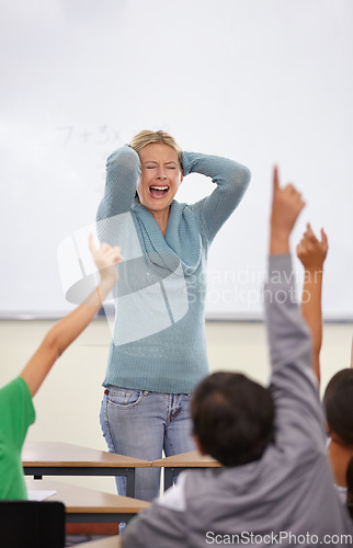 Image of Angry teacher, classroom and shout at kids with raised hand for questions, answer or pop quiz with stress. Teaching woman, children and education with frustrated face, talking and anxiety at school