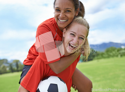 Image of Happy woman, friends and piggyback with soccer ball on green grass for winning, achievement or sports in nature. Portrait of female person or football player smile for hug, match or game on field