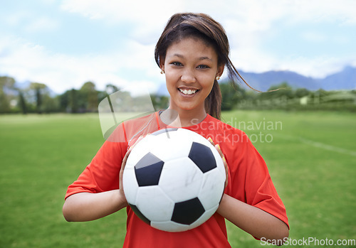 Image of Woman, football field and portrait with ball, happy and soccer player for match, competition and game. Fitness, practice and ready for training, outdoor and exercise for athlete, fun and sport