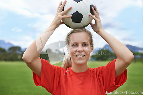 Image of Happy woman, portrait and soccer ball for sports game, throw or playing match in exercise on green grass. Face of young female person or football player smile in training or practice on outdoor field